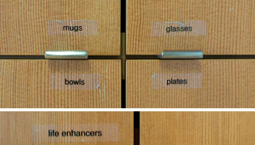 Kitchen cupboard labels: mugs, glasses, bowls, plates, life enhancers. All in a days work at Ziba.