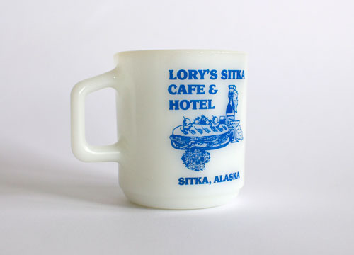 Lory's Sitka Cafe and Hotel - milk white mug with blue screen printing of a sandwich and drink.