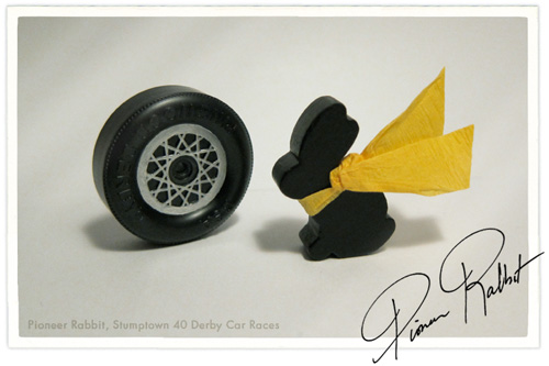 My pioneer rabbit poses in his jaunty yellow crepe paper scarf next to his custom rims.