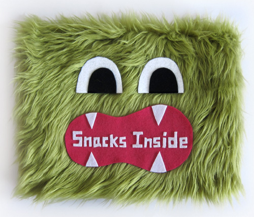 Goodie Monster vending machine sign made out of green faux fur and a hungry monster mouth.