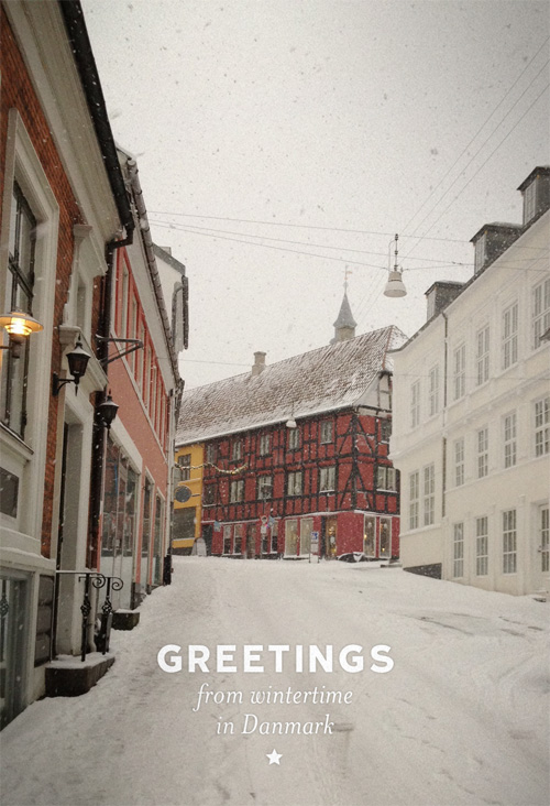 A wintry scene from Fyn Denmark during the month of December. A deserted walking street the day before Christmas with old buildings and street lamps.