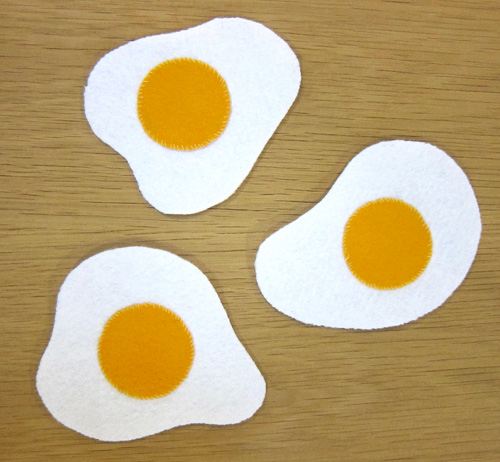 Hand sewn felt coasters that look like sunny side up eggs. Set of 3.