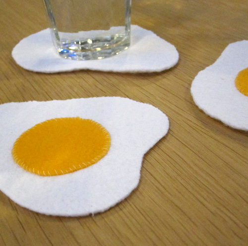Hand sewn felt coasters that look like sunny side up eggs. Set of 3.