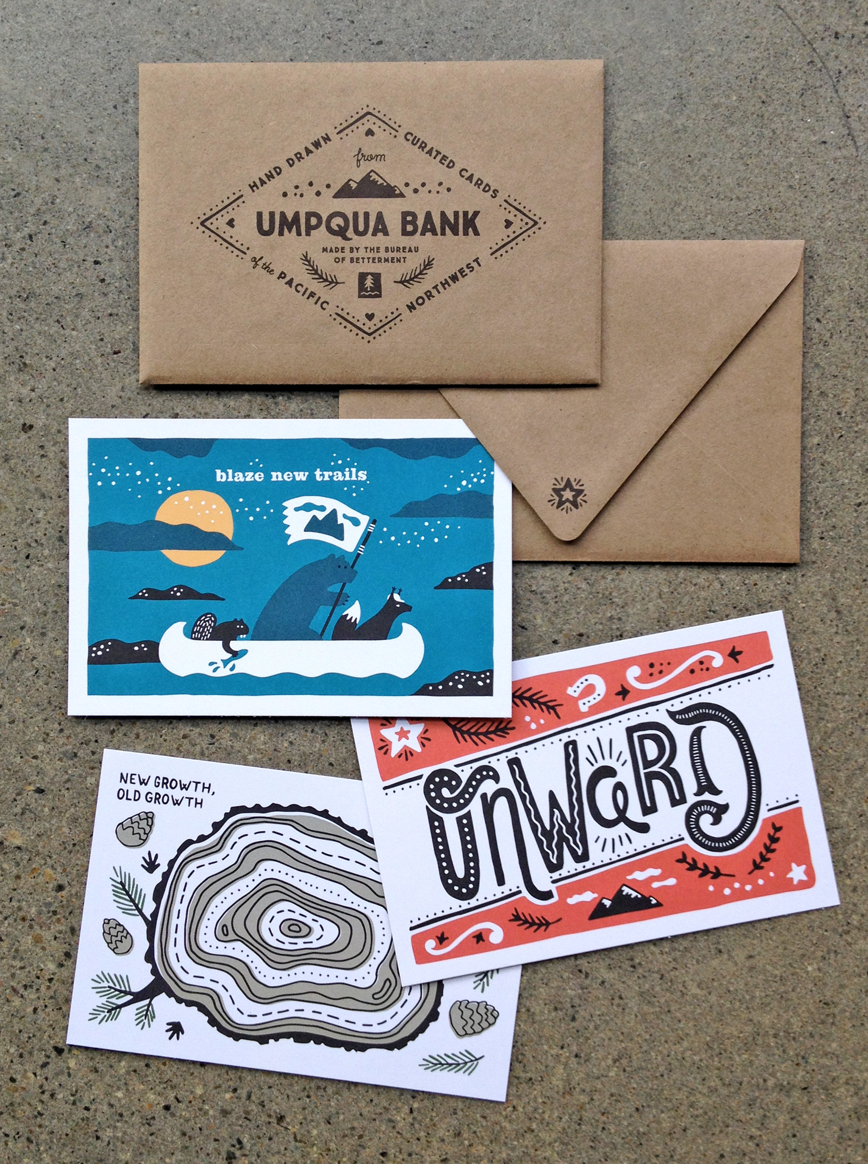 set of three postcards and envelope for Umpqua Bank - blaze new trails, onward, and old growth new growth