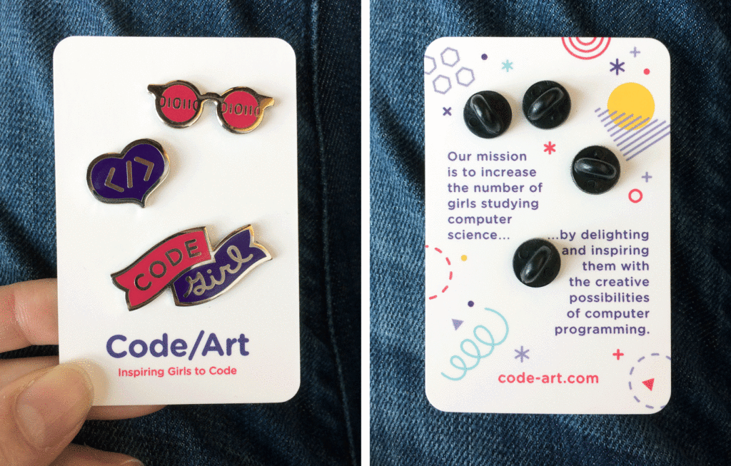 Enamel pin trio: 01100111010111 code sunglasses (cool shades), a </> heart, and code girl banner.” class=”wp-image-8341″/></figure>



<figure class=